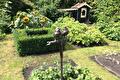 Bronzen vogeltjes op een staaf in de tuin met buxushaag